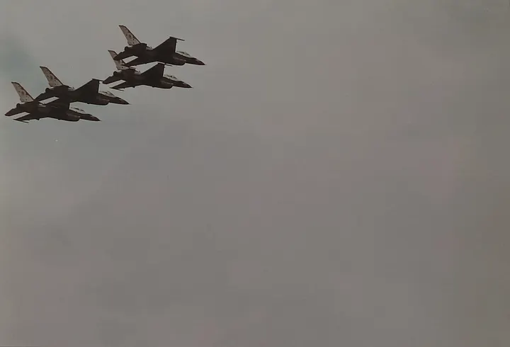 Four military jets flying in a tight formation