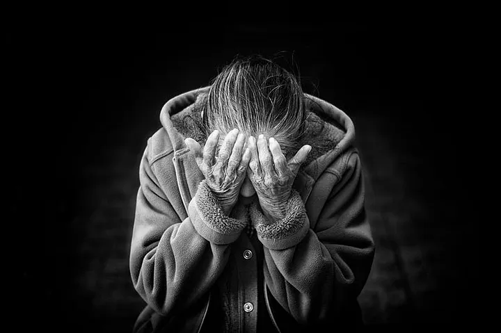 Alzheimer’s Patient with Head in Hand