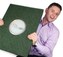 The inventor of kinetic Tiles holding his product