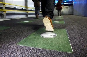 Image of a child's shoe stepping on a Kinetic Tile in a middle school hallway