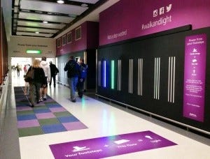 Kids in school walking down a hallway installed with Kinetic Tiles
