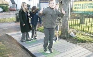 Middle school kids walking on a Kinetic Tiles outdoors walkway