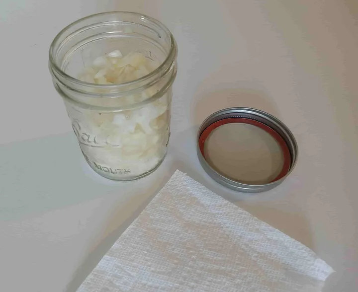 Opened mason jar full of chopped onions