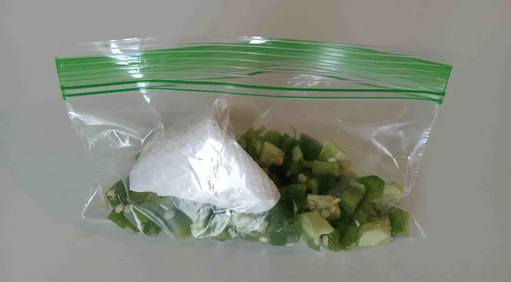 Chopped jalapenos in a baggie with a small piece of a paper towel