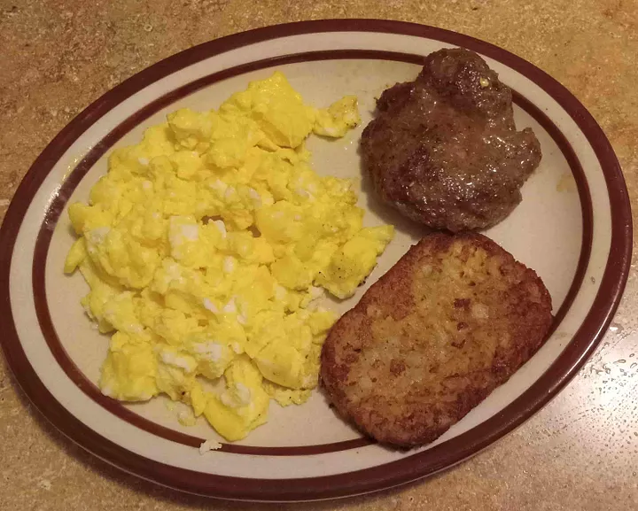 Eggs and hash brown patties on a platter