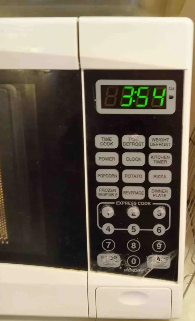 Microwave clock reads 3:54